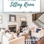 farmhouse style living room pin - 4 beige armchairs on the edges of a blue and white plaid rug with a round wicker coffee table in the center.