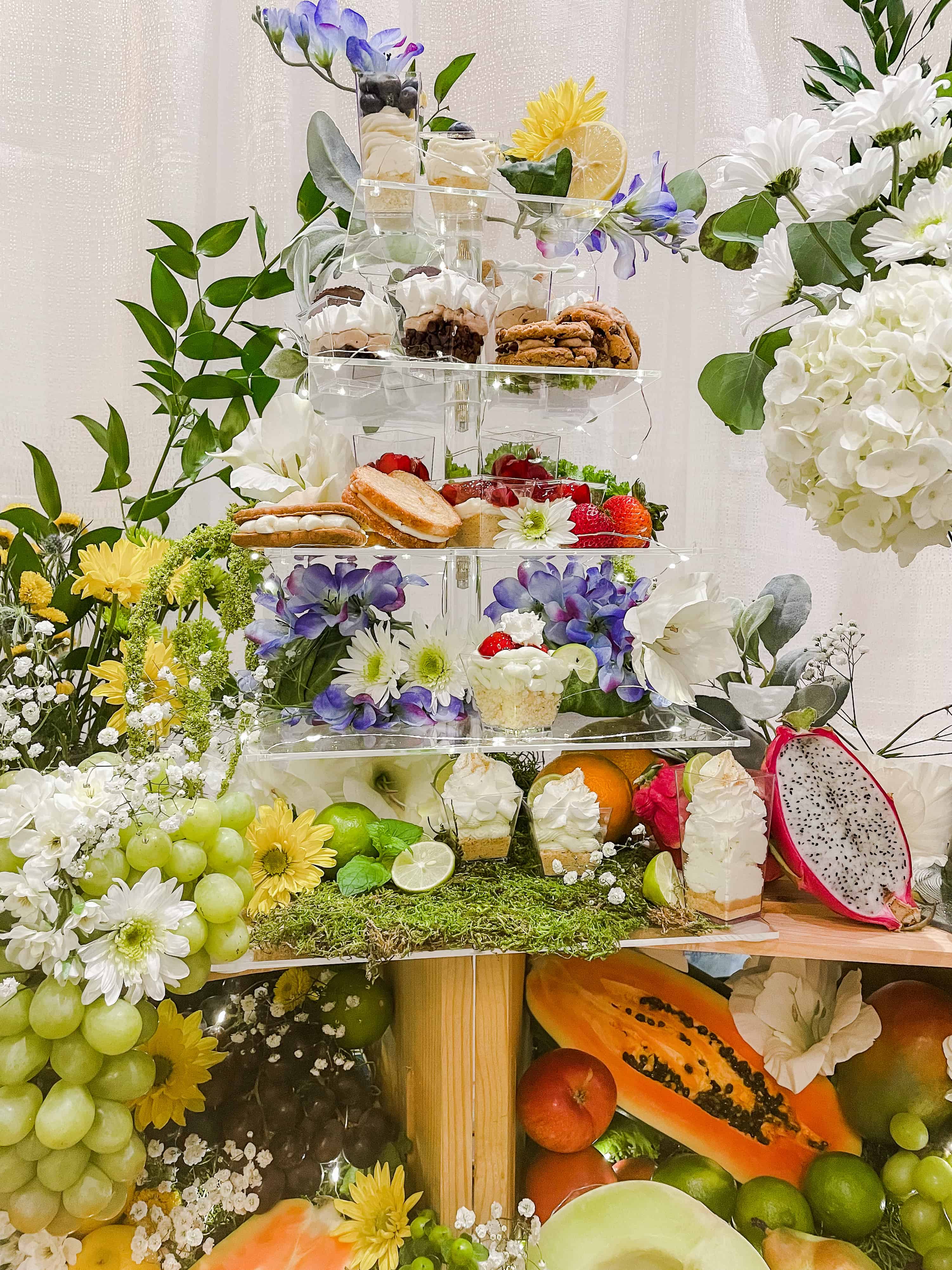 Floral display for food with 3 tiers and small desserts displayed