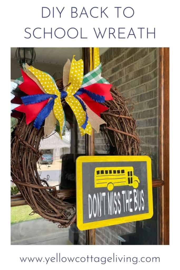 Grapevine wreath with colorful bow and rectangular chalkboard sign that has a yellow school bus and says don't miss the bus.