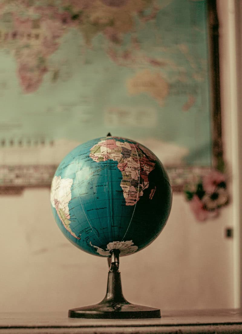 10 ways to make school day mornings easier picture with a globe in the center and a map in the background on the wall