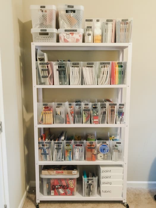 get organized with white book case with clear bins filled with craft and art supplies