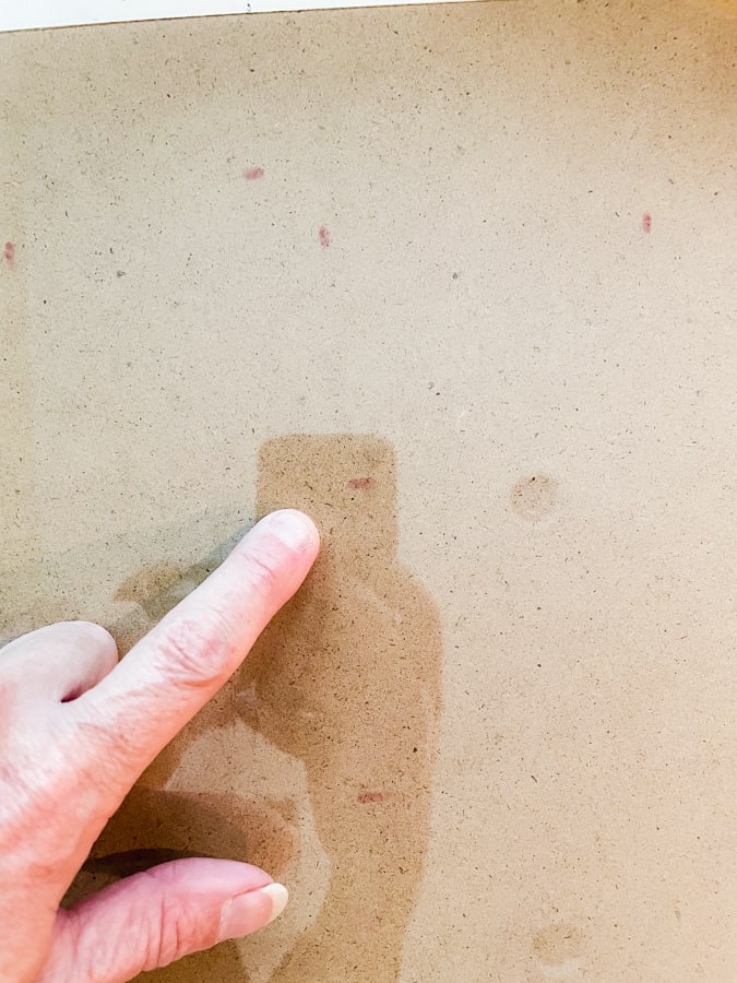 finger pointing to a red dot on a brown background instructions for making a large wall calendar