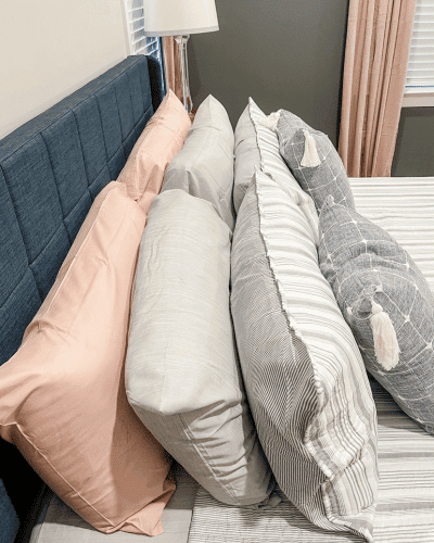 master bedroom refresh - pillows stacked on the bed.