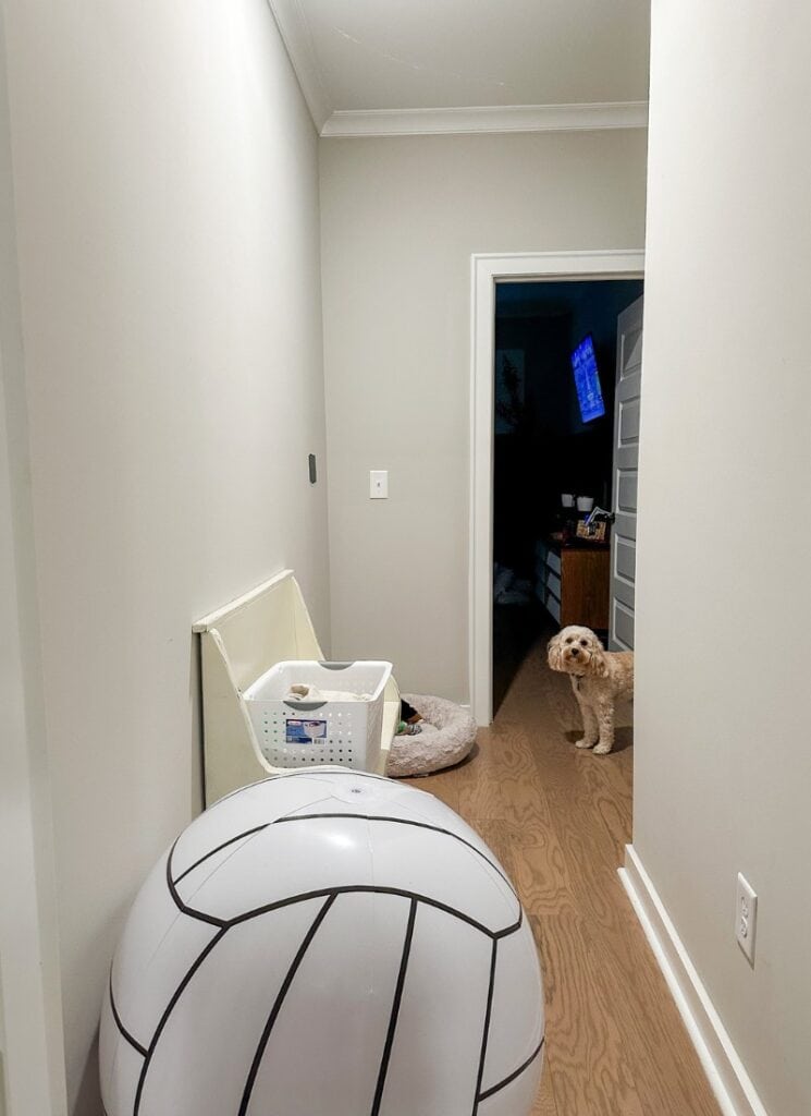 plain hallway to be transformed with backpack hooks and vertical shiplap